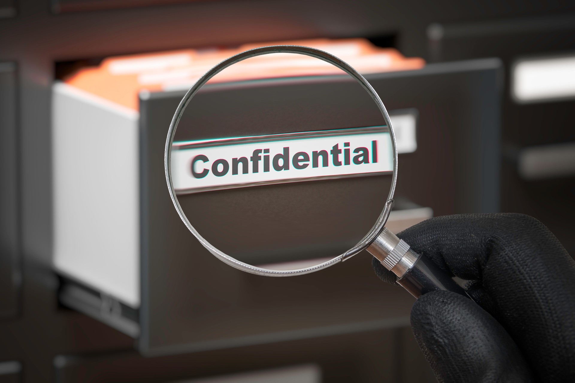 Man with magnifying glass looking on confidential secret files.