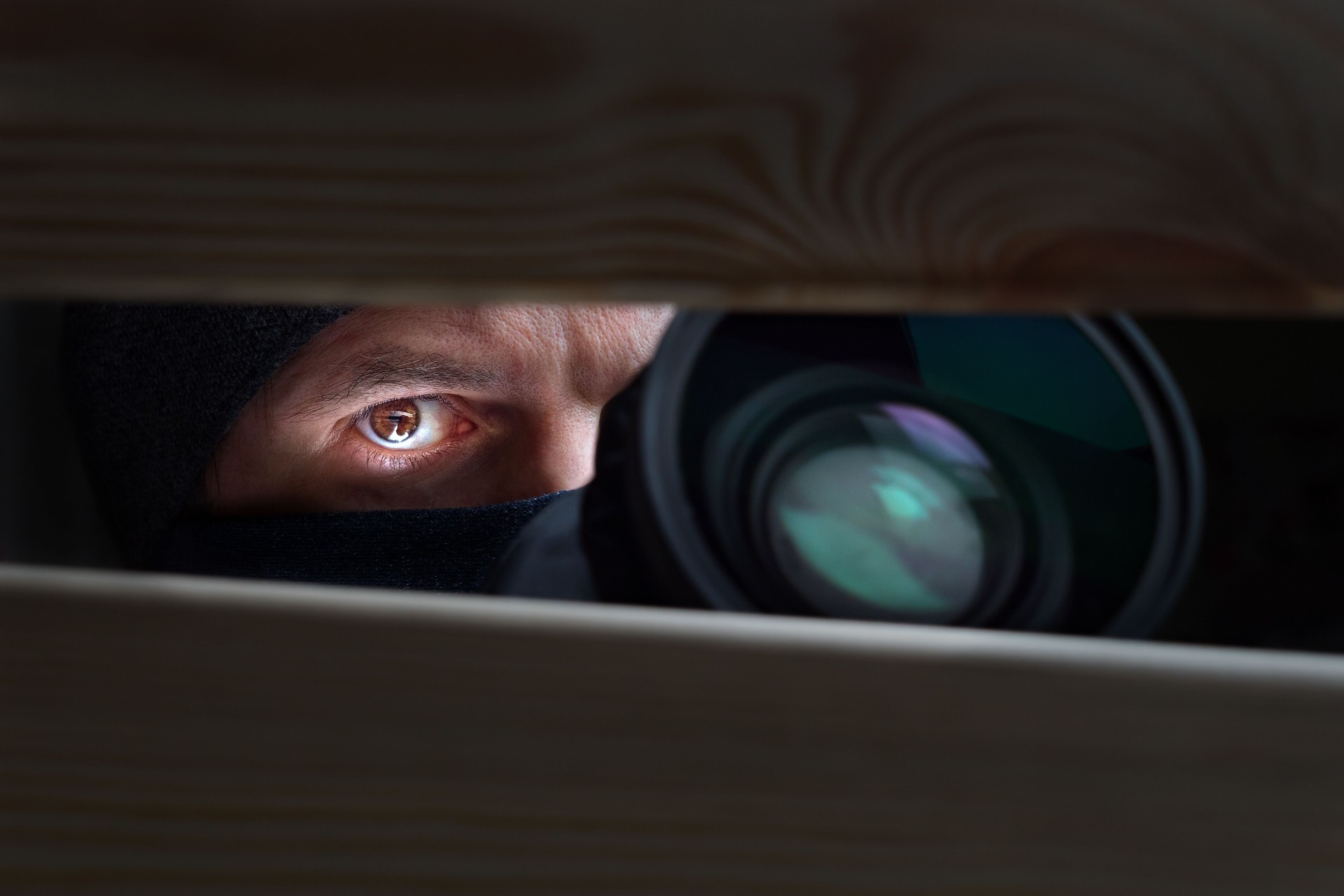 Private detective, undercover cop, investigator, spy or paparazzi with camera taking photos. Agent or police spying, investigating or following people. Espionage or surveillance concept. Man hiding