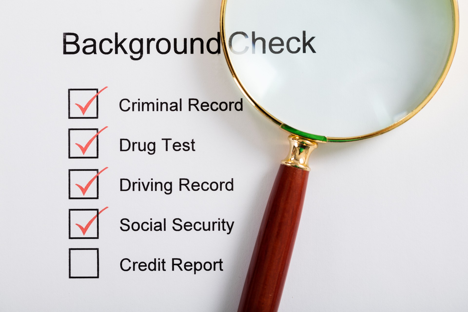 Magnifying Glass Over Background Check Form